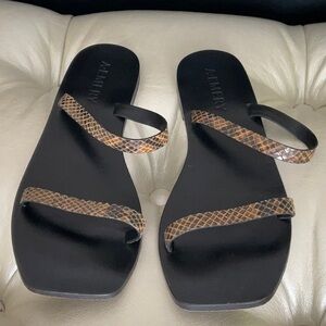 A. Emery brown and black leather sandals. Size 38.